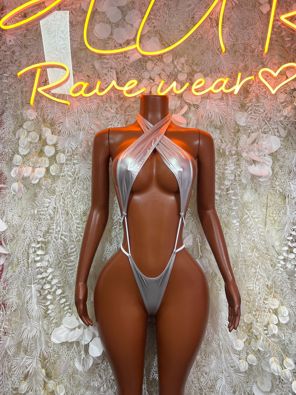 Metallic silver latex bodysuit with halter neckline and thong-style cutout back