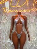 Metallic silver latex bodysuit with halter neckline and thong-style cutout back