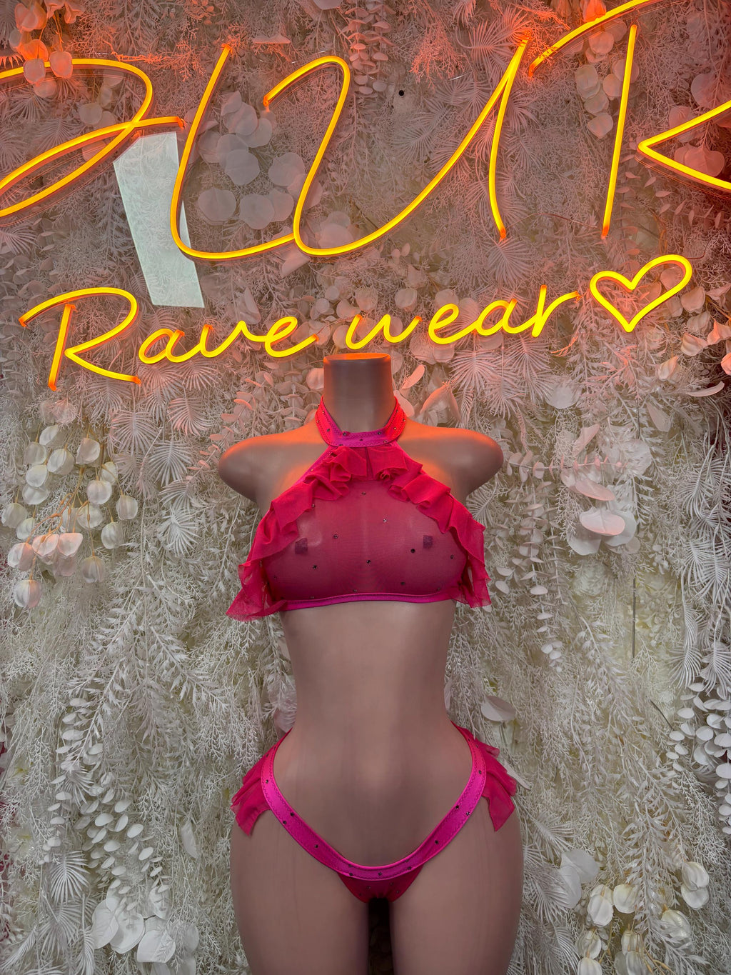 Pink two-piece dancewear set with halter top and ruffle bottoms
