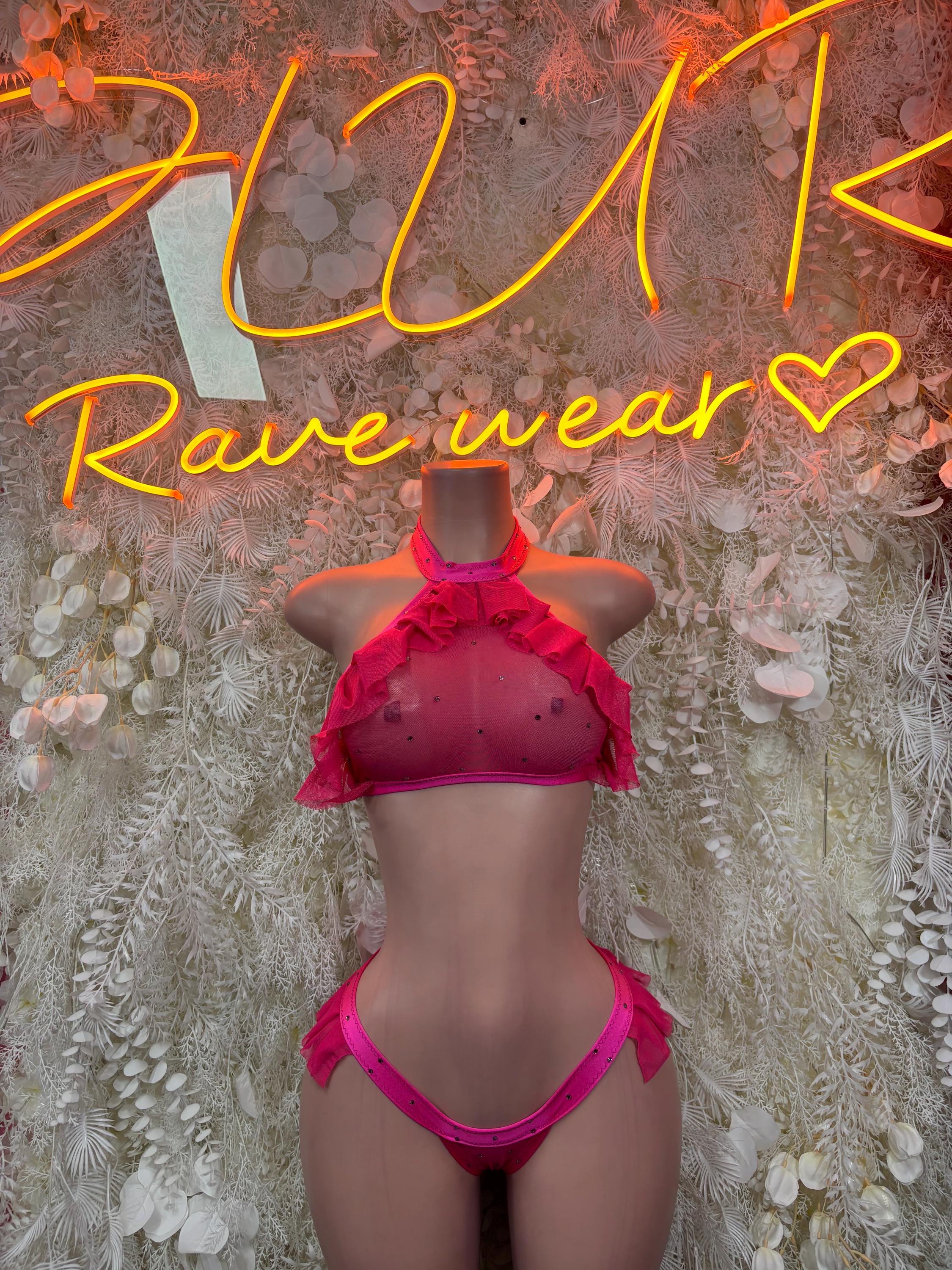 Pink two-piece dancewear set with halter top and ruffle bottoms