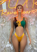 Women’s Jamaica-flag style bodysuit with green, black, and yellow panels, front lace tie