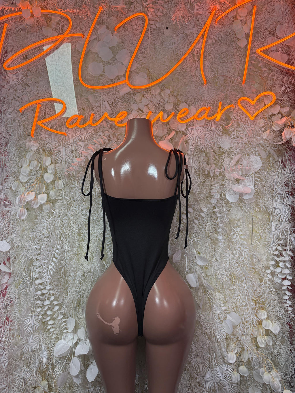 Black cheetah print bodysuit with deep V neckline, lace-up sides, and tie straps