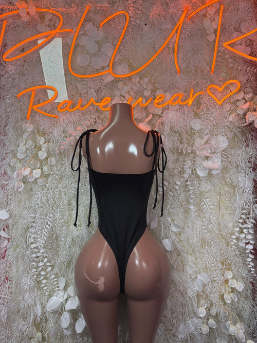 Black cheetah print bodysuit with deep V neckline, lace-up sides, and tie straps