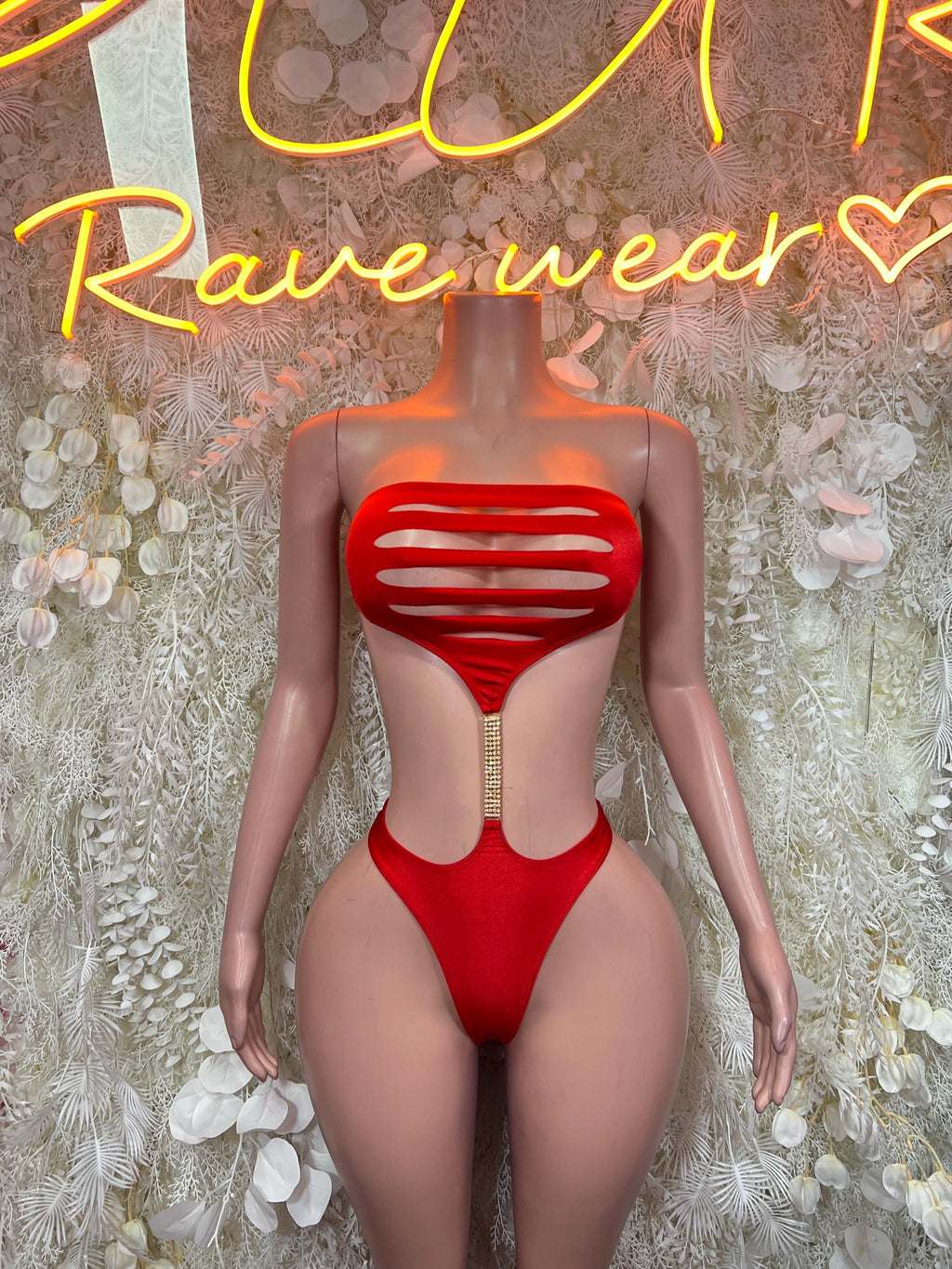 Red one-piece bodysuit with striped chest cutouts and high-leg cut