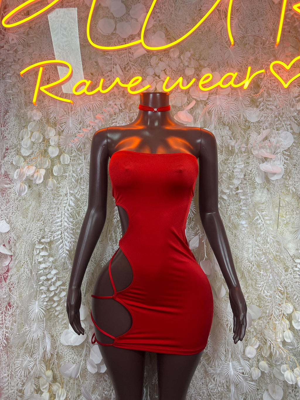 Red strapless mini dress with side cutouts, tie straps, and choker-style neck detail