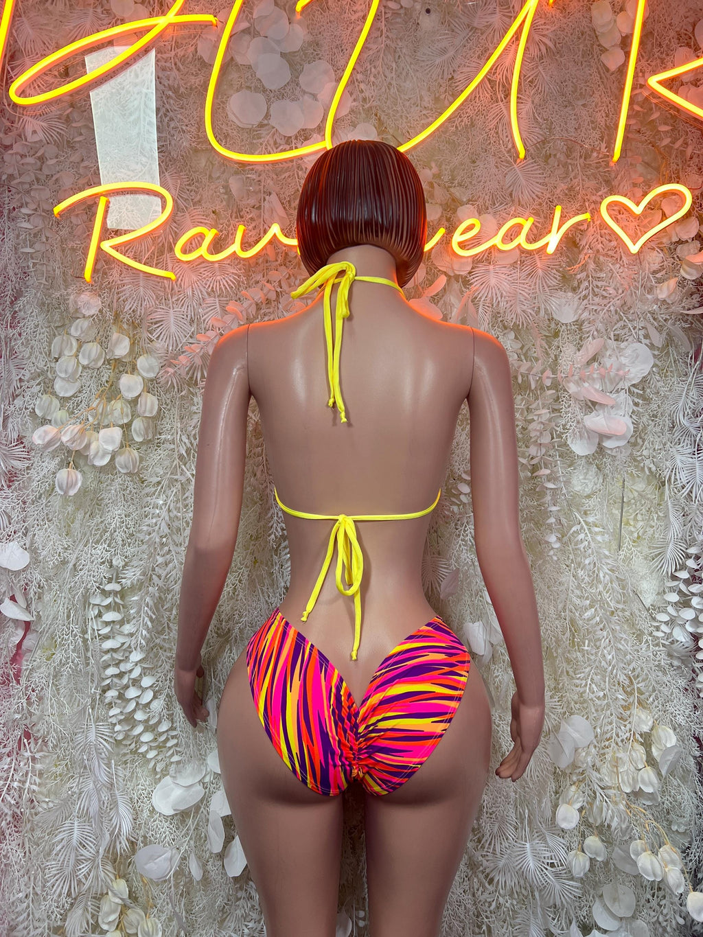 Back view neon zebra print monokini with tie straps and O-ring, high-cut one-piece