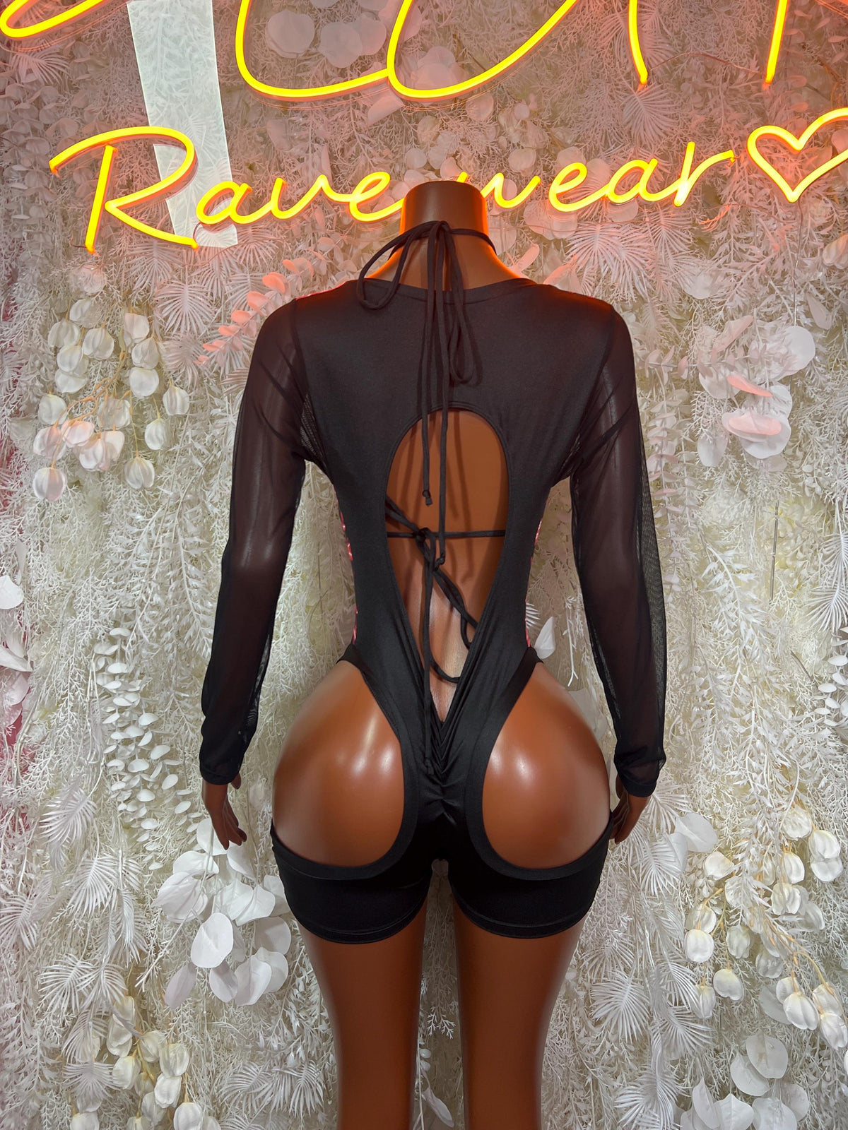 Back view red lightning one-piece bodysuit with sheer mesh sleeves and crisscross straps