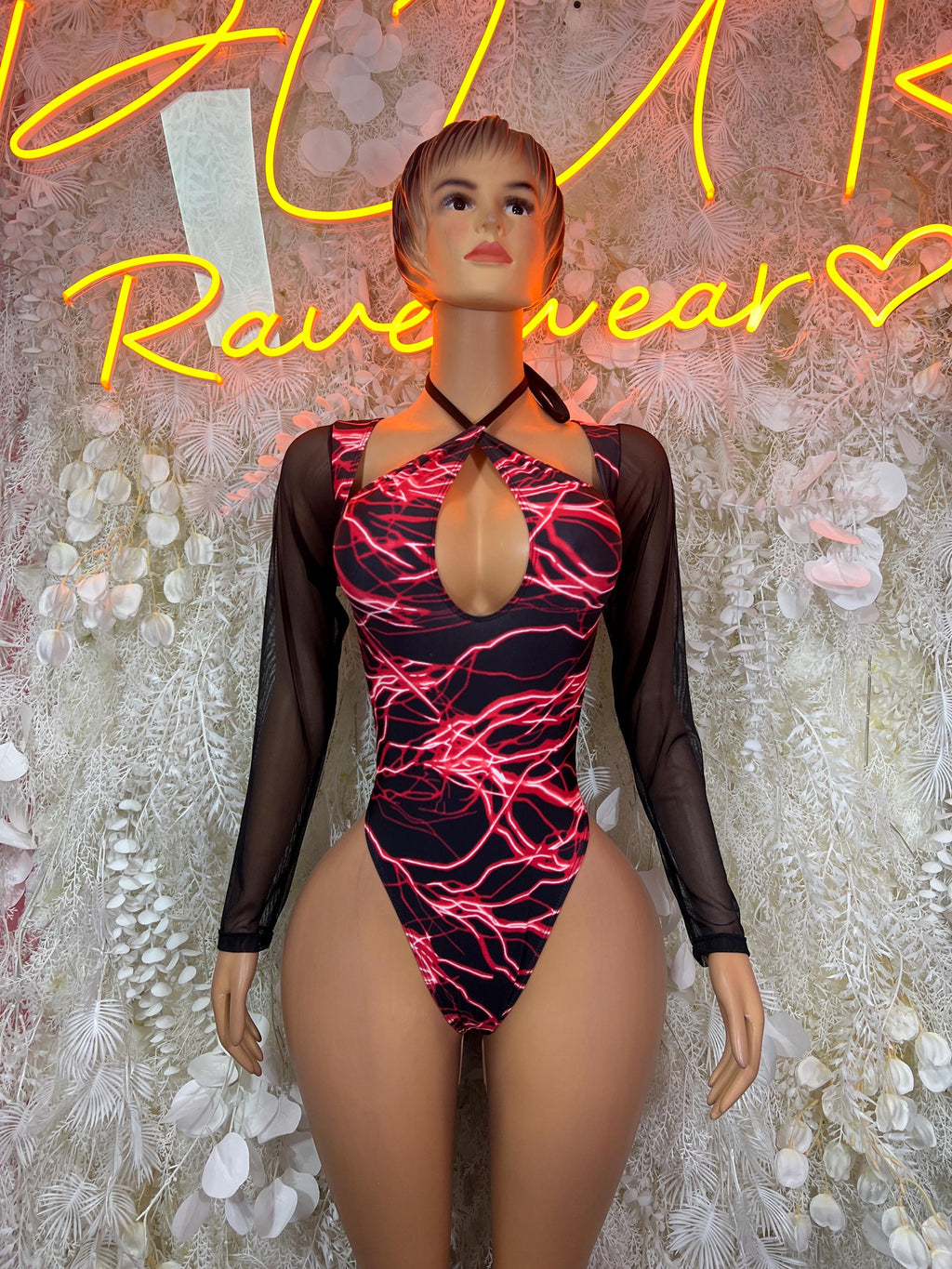 One-piece bodysuit with red lightning print, black sheer sleeves, deep front keyhole