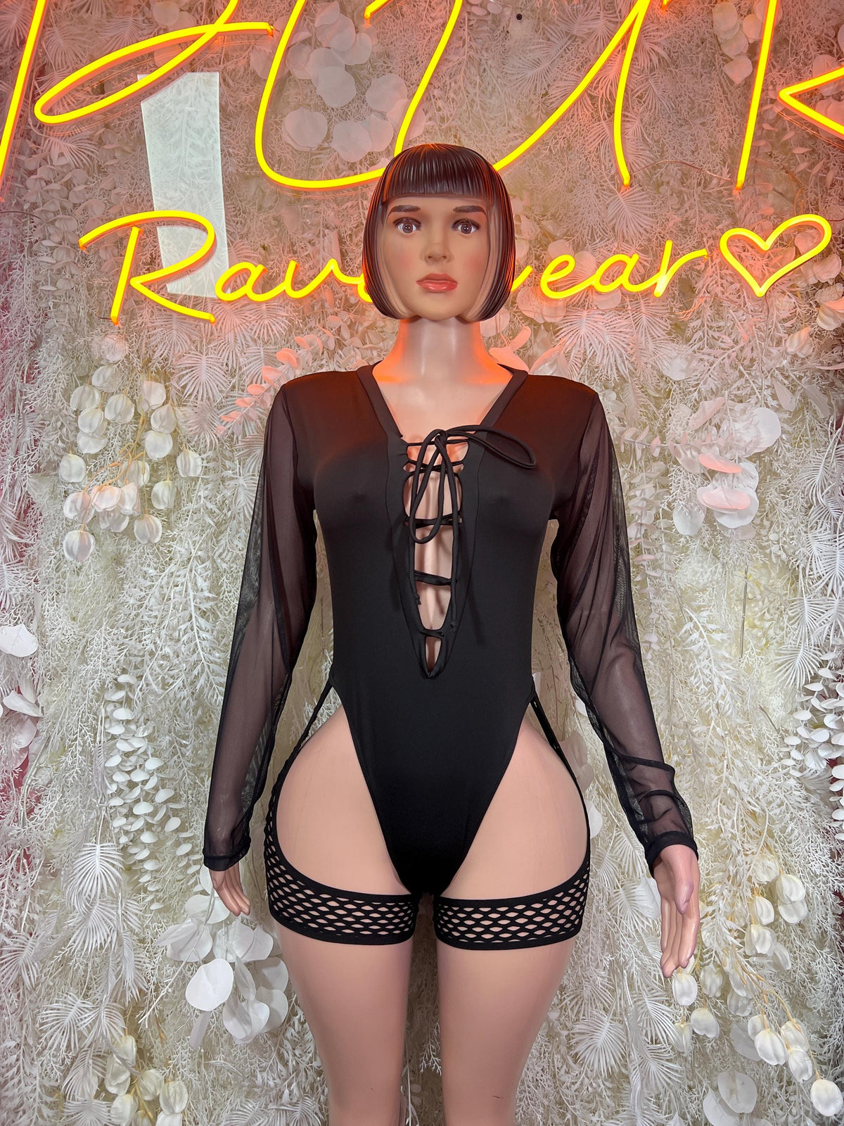 Black one-piece bodysuit with sheer long sleeves and lace-up V-neck front