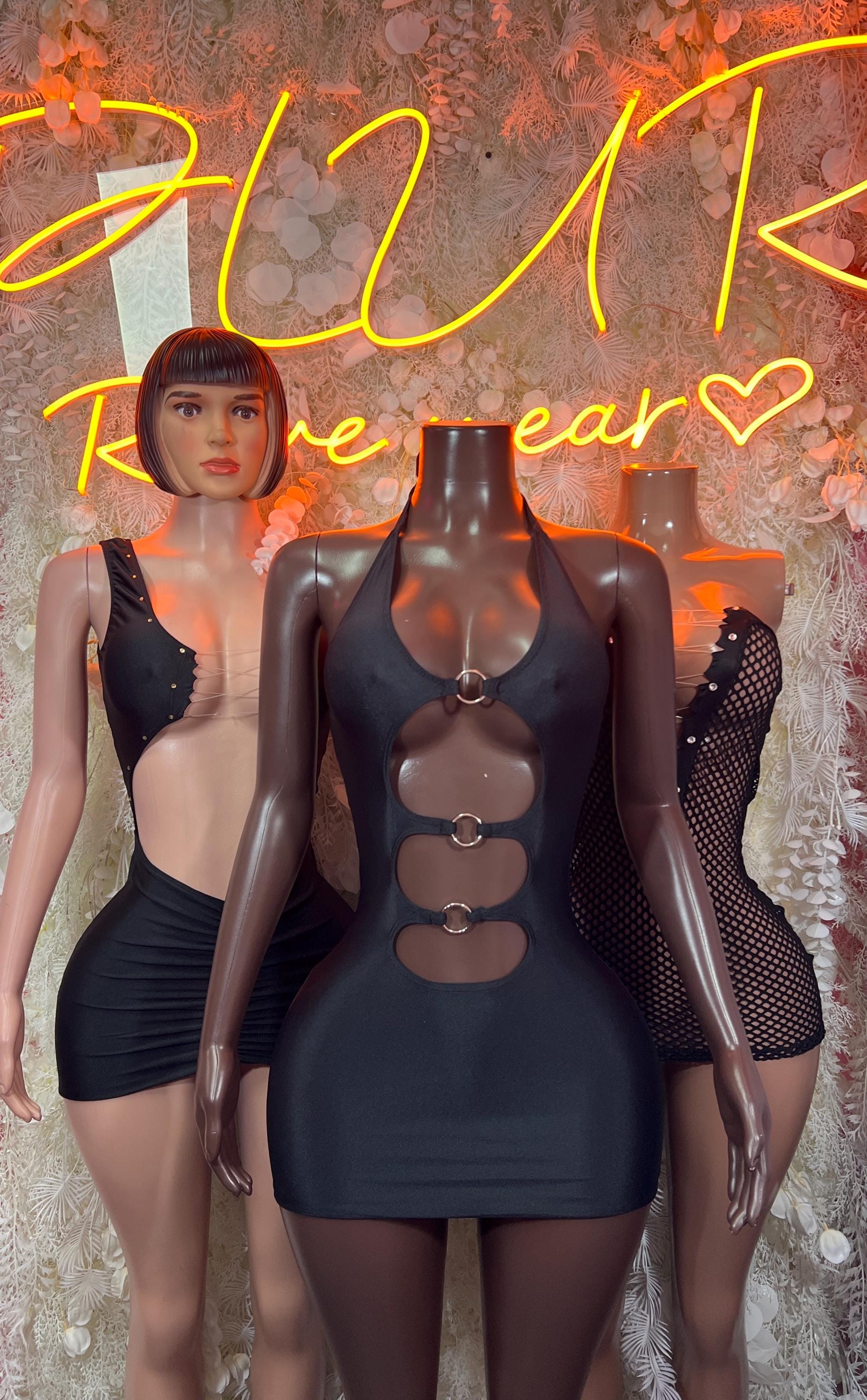 Black halter mini dress with central ring hardware and chest cutout panels