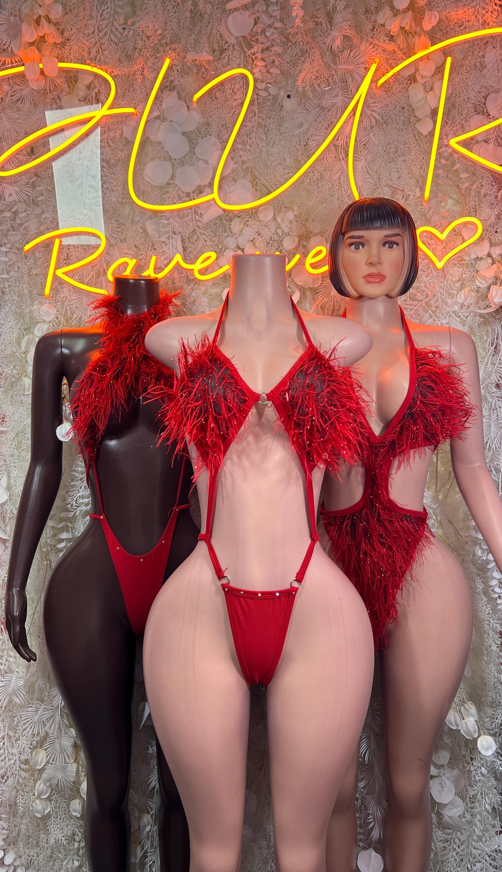 Red feather fringe bikini tops and matching bottoms on mannequins, side-by-side
