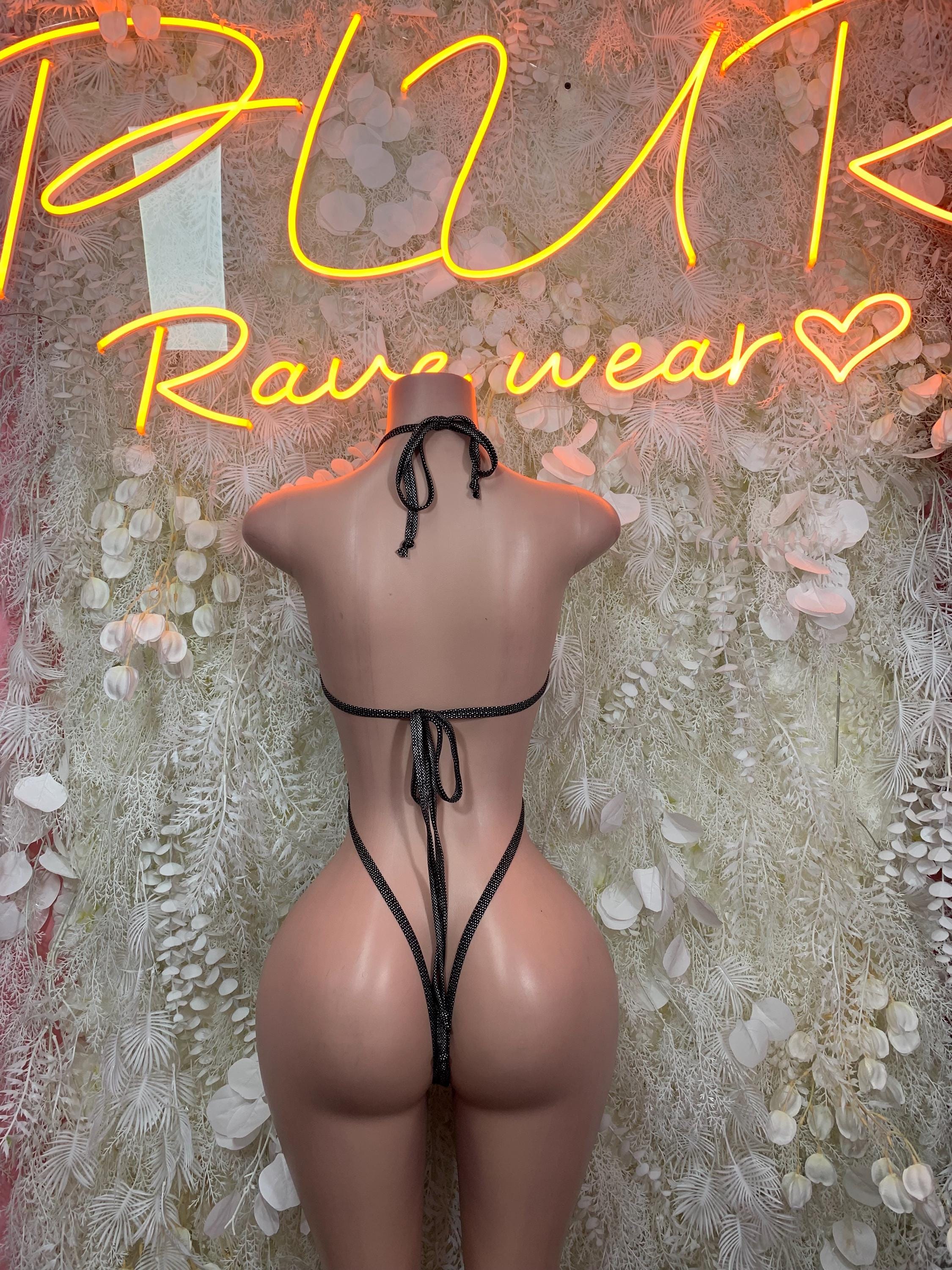 Matte black latex slingshot bodysuit with crisscross tie-back and thong back