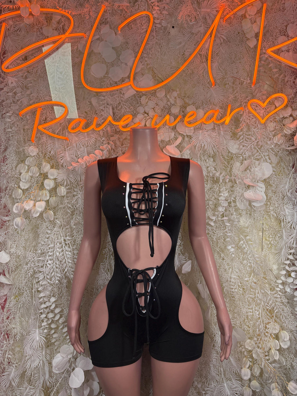 Black referee-style bodysuit with lace-up front, long sleeves, chest and thigh cutouts