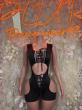 Black referee-style bodysuit with lace-up front, long sleeves, chest and thigh cutouts
