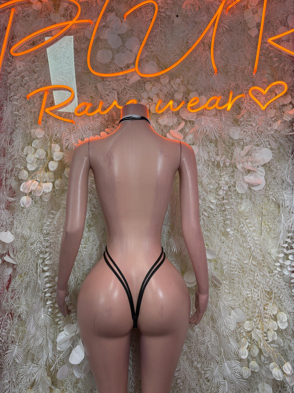 Referee-style bodysuit back view with black halter straps and striped cutout.