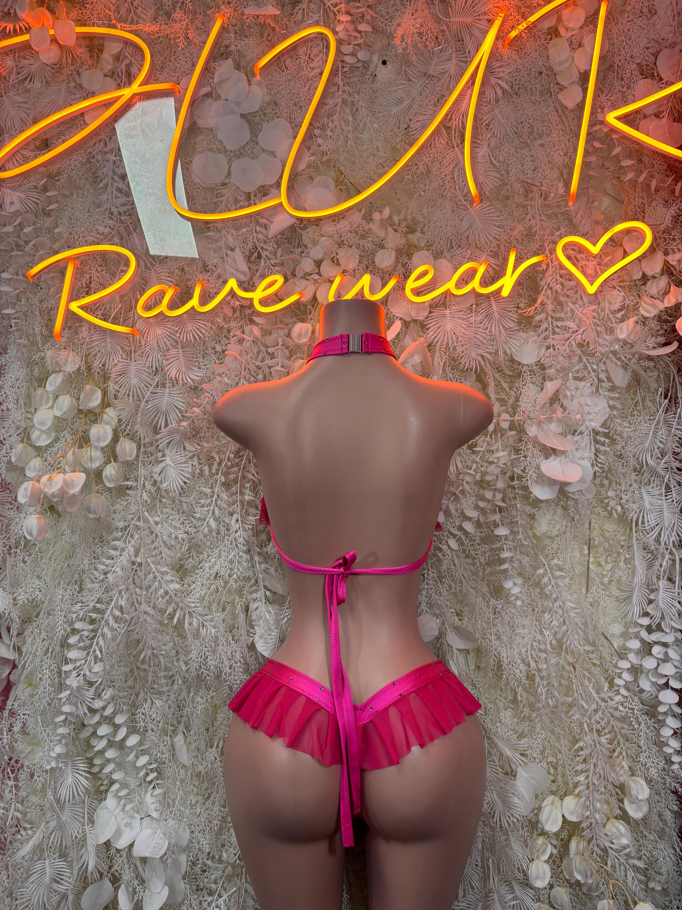 Pink two-piece dancewear set viewed from back, halter and tied ruffle bottoms