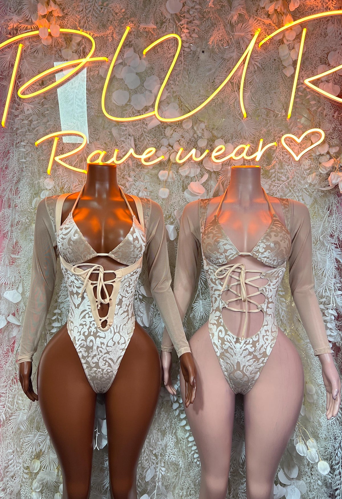 Pair of champagne gold lace criss-cross cutout bodysuits with long sheer sleeves