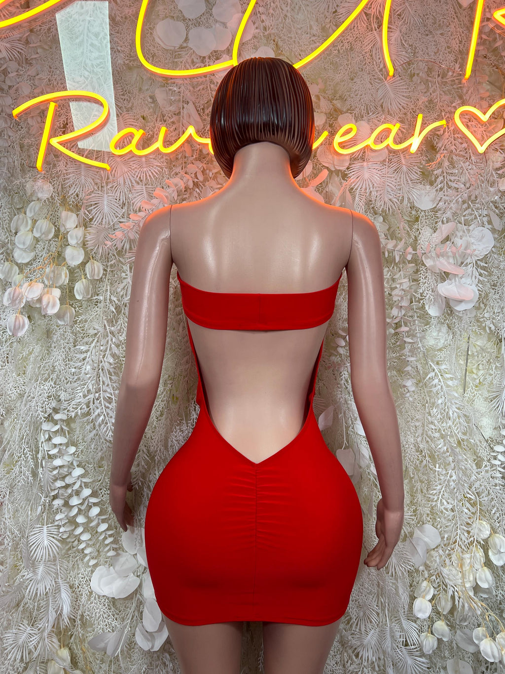 Red bodycon mini dress shown from back, with strapless back cutout