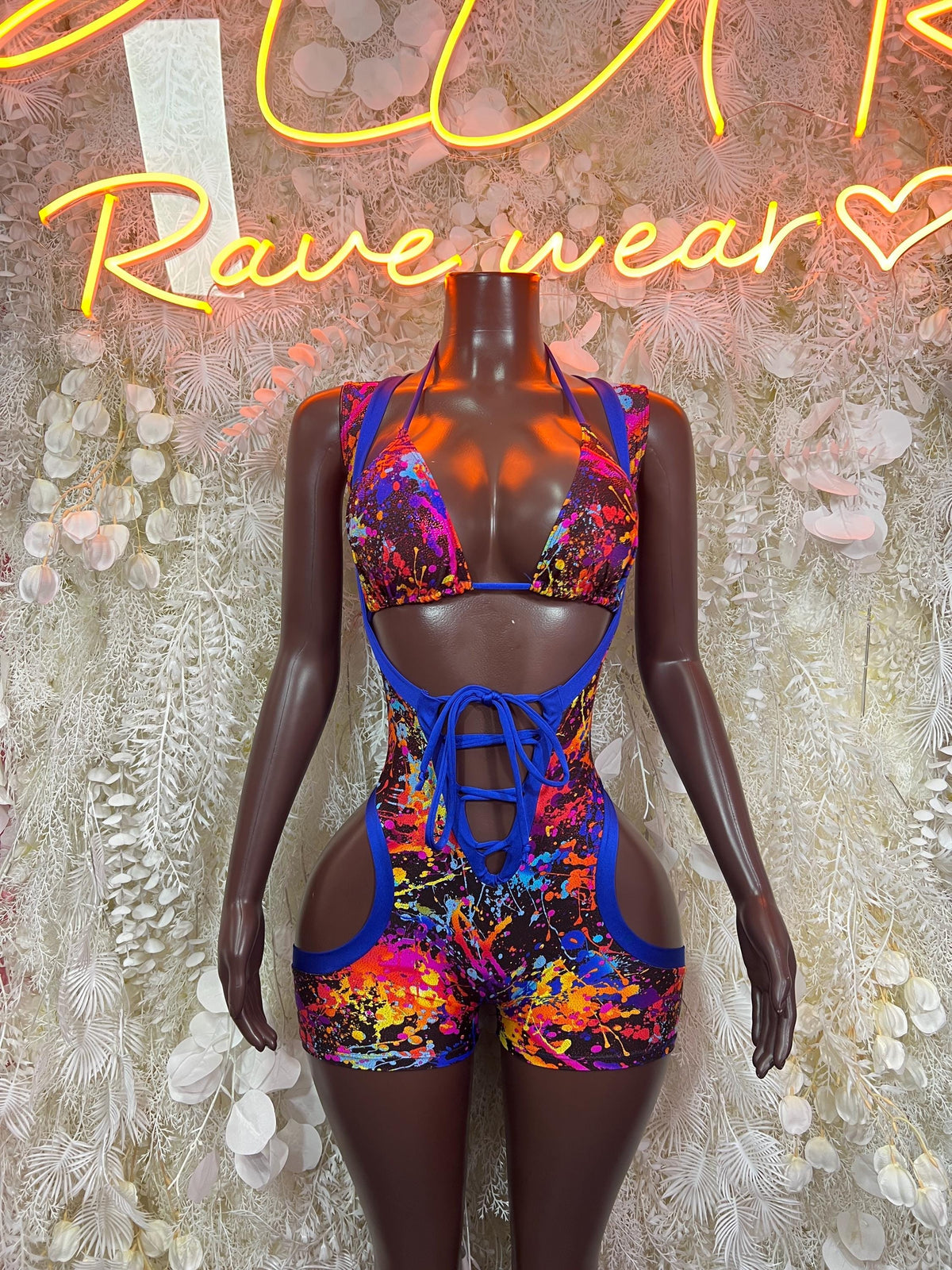 Multicolor paint-splatter bodysuit with blue straps and lace-up back, sleeveless