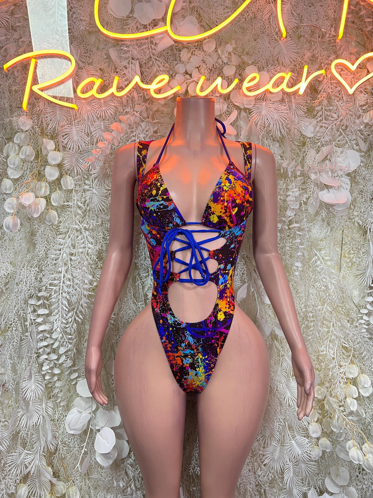 Paint-splatter one-piece bodysuit with blue lace-up cutout, halter straps