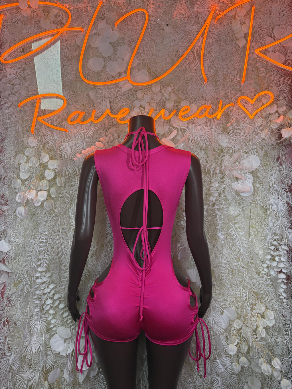 Pink halter bodysuit with open back and crisscross lace-up straps