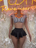 Two-piece referee outfit: black ruffled mini skirt and black-and-white striped crop top