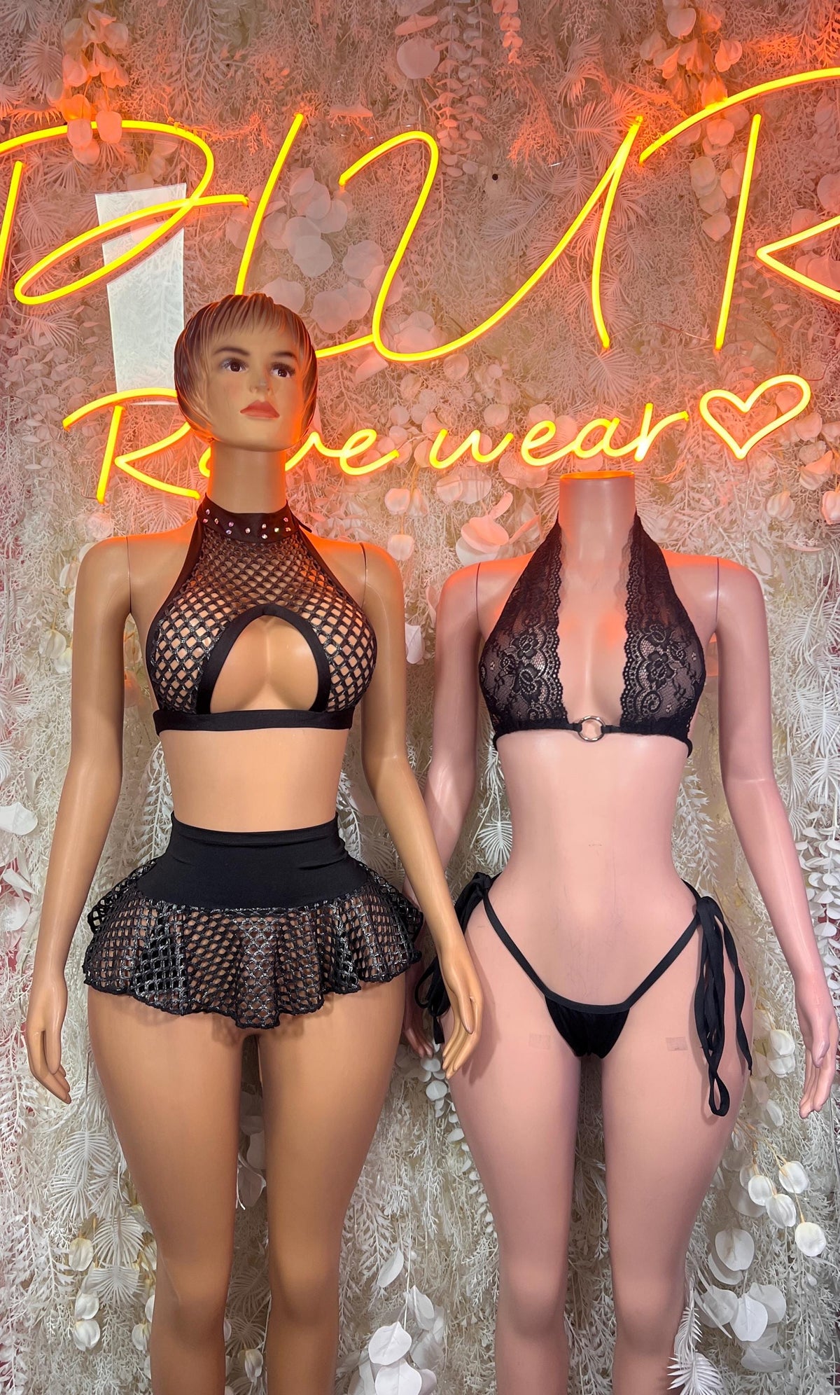 Black fishnet halter crop top with ruffle skirt, front view of festival costume on two models