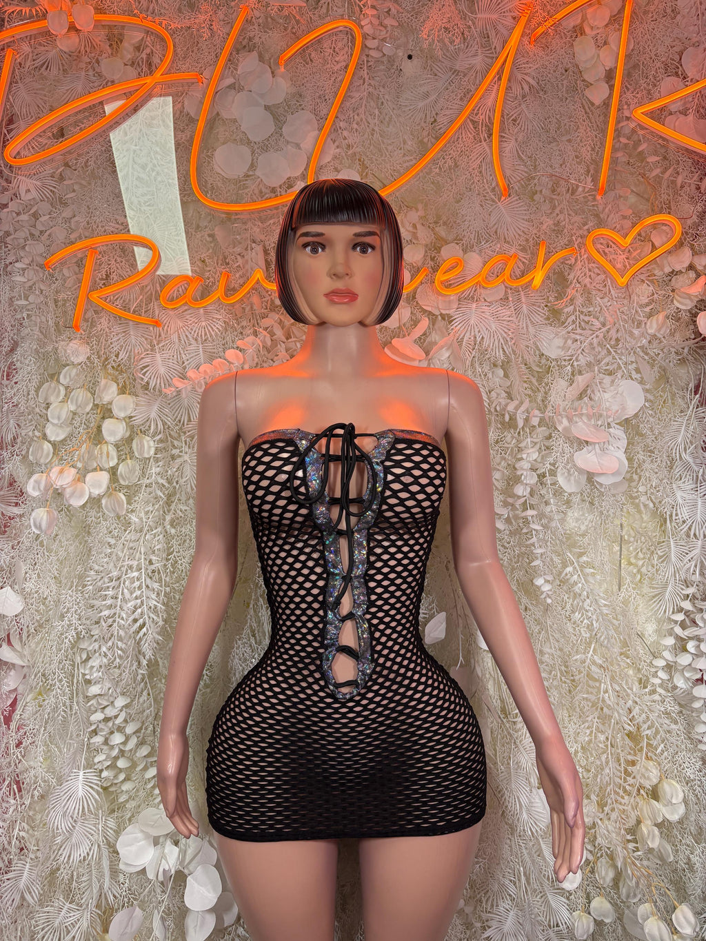 Black fishnet mini dress with lace-up front and high neckline