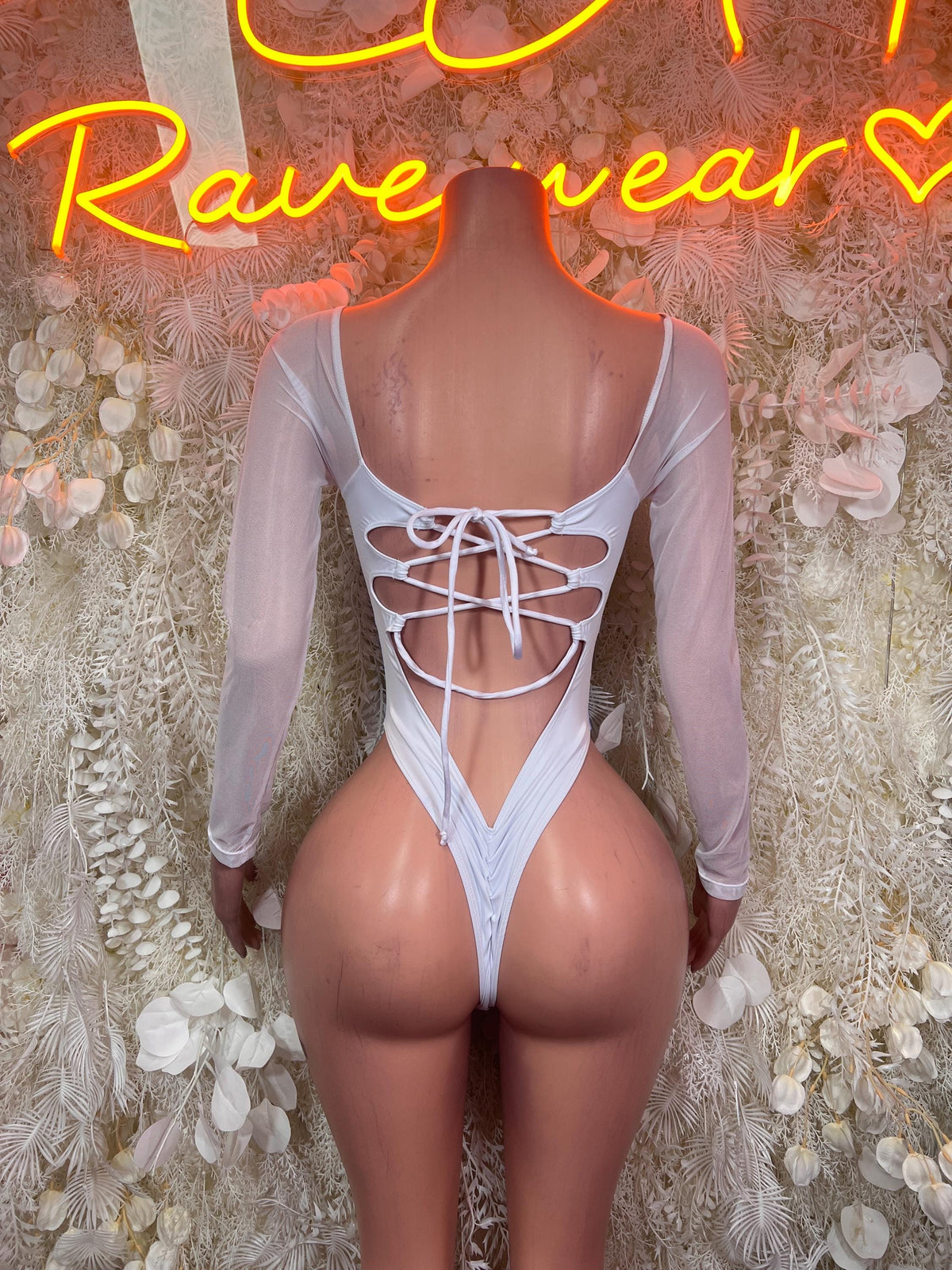 White long-sleeve bodysuit with lace-up neckline and high-cut briefs