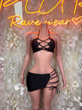 Black strappy halter crop top with lace-up front and matching mini skirt, front view
