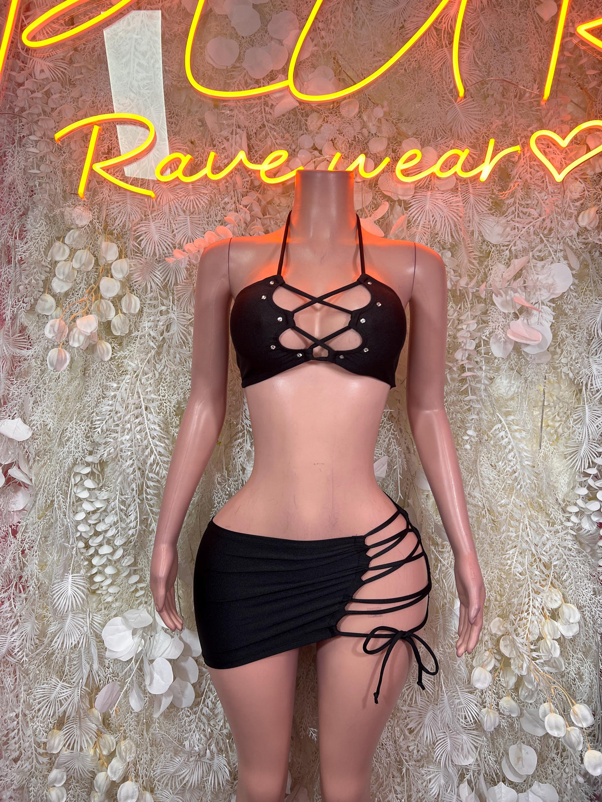 Black strappy halter crop top with lace-up front and matching mini skirt, front view
