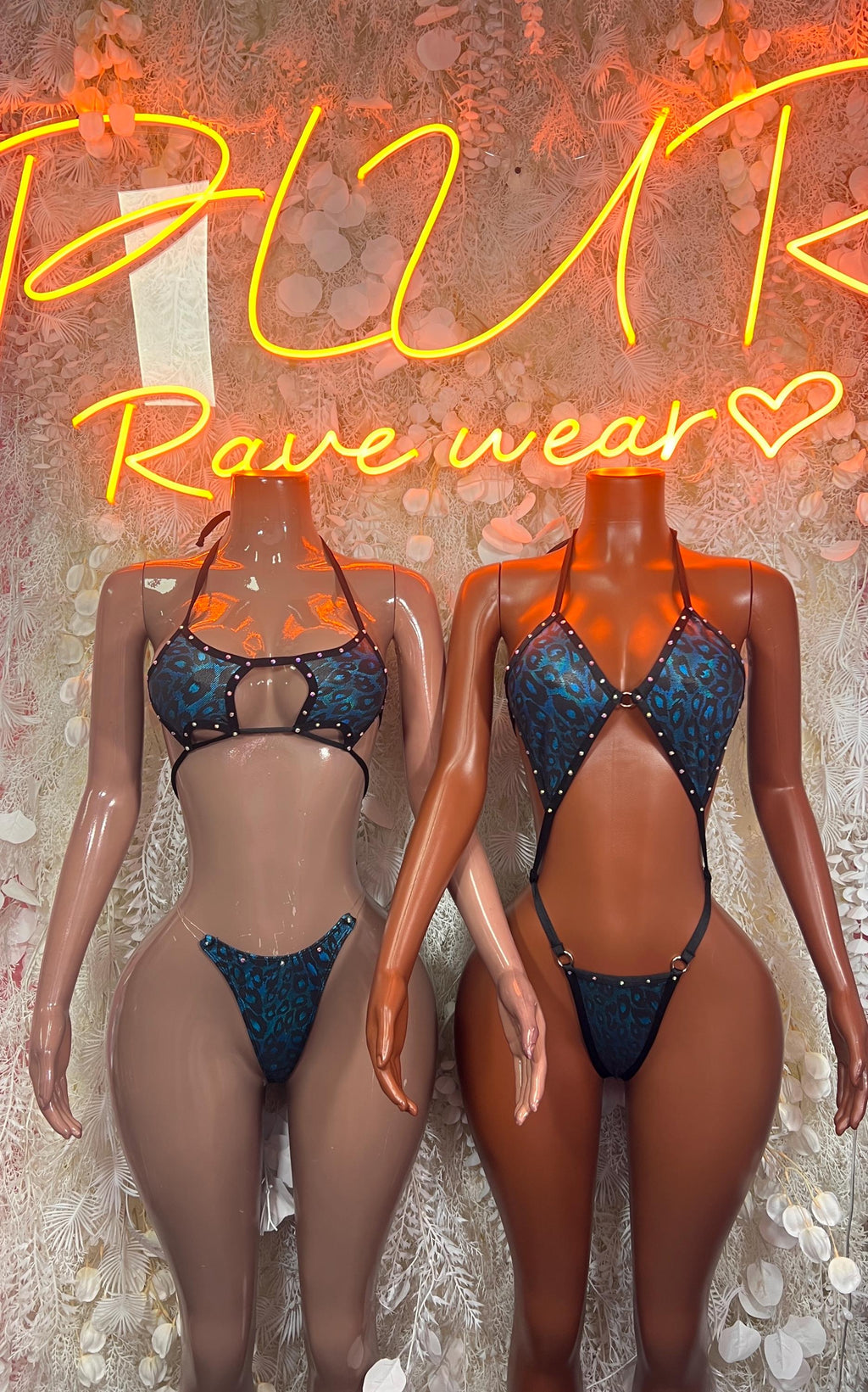 Two blue leopard print monokini bodysuits with black straps, front view