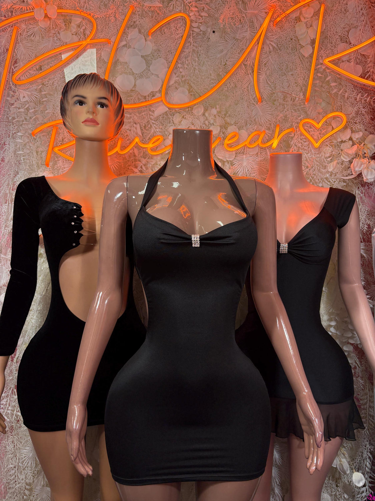 Black long-sleeve mini dress with deep neckline and back cutout