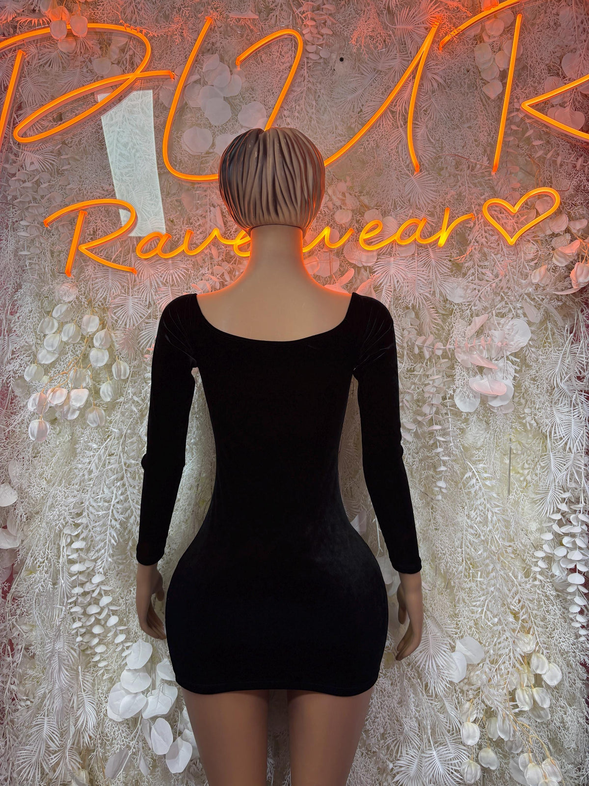 Black long-sleeve mini dress with low back and fitted silhouette