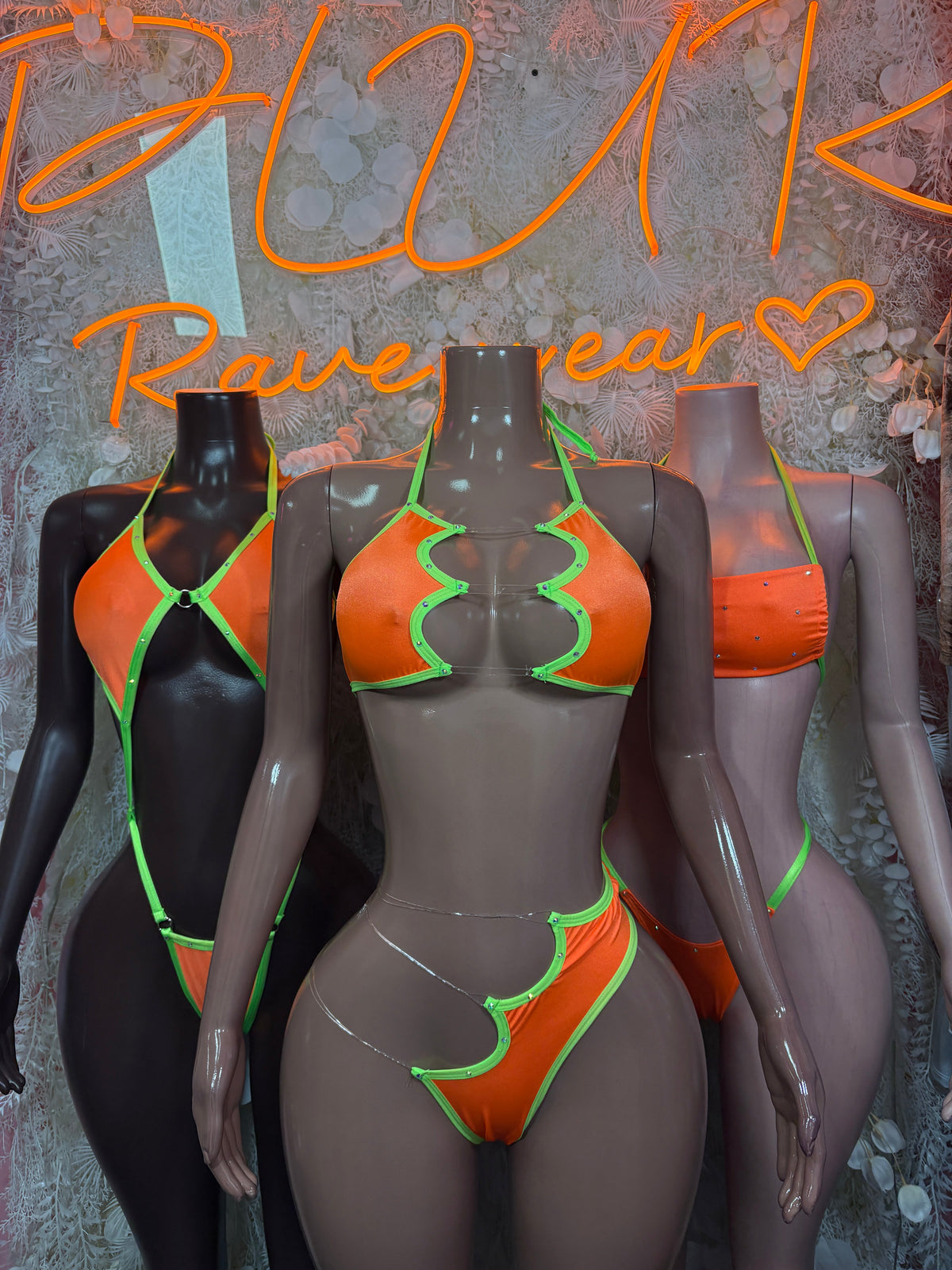 Neon orange and lime zigzag cutout rave bodysuit on black base, front strap detail