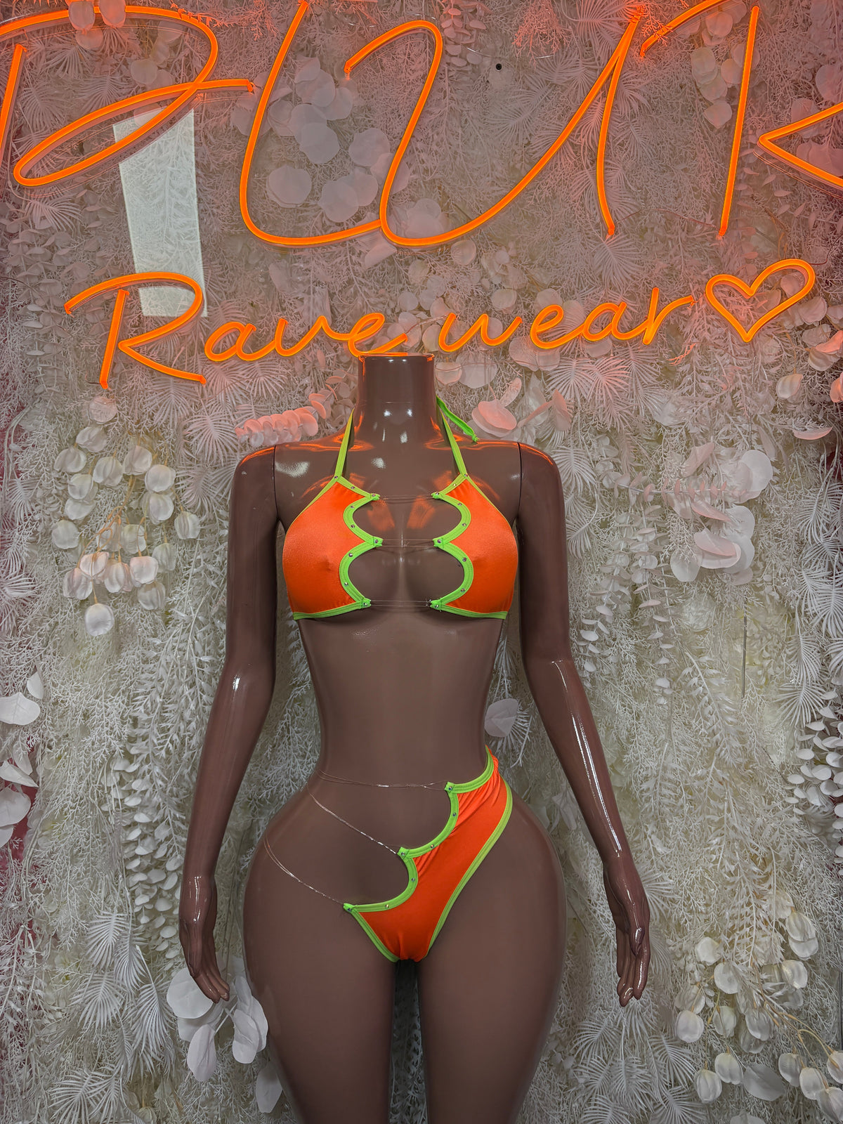 Neon orange and lime zigzag cutout rave bodysuit with high-cut bottoms and strappy ties
