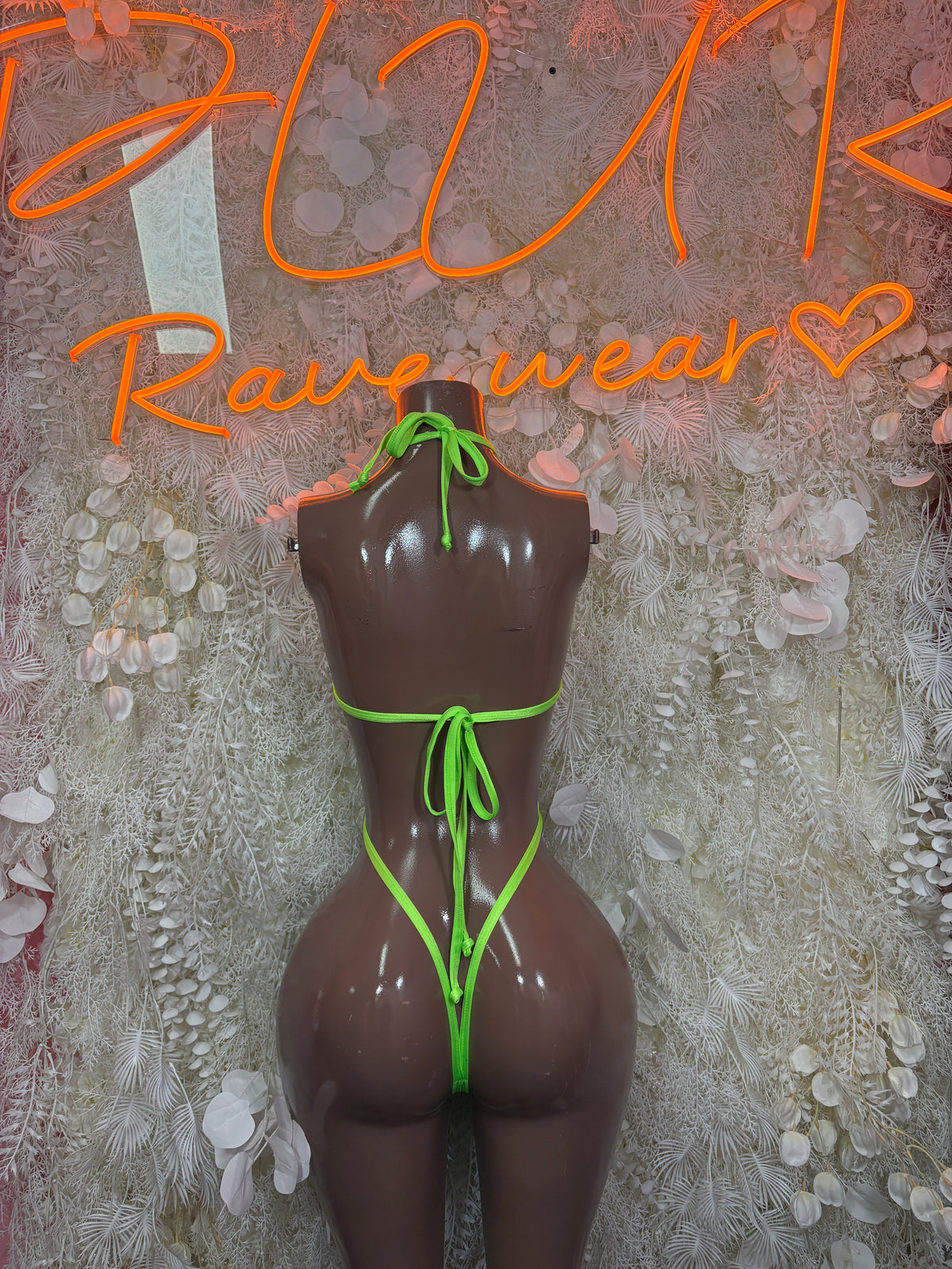 Neon orange and lime cutout cross-strap rave bodysuit, tie-front on mannequin