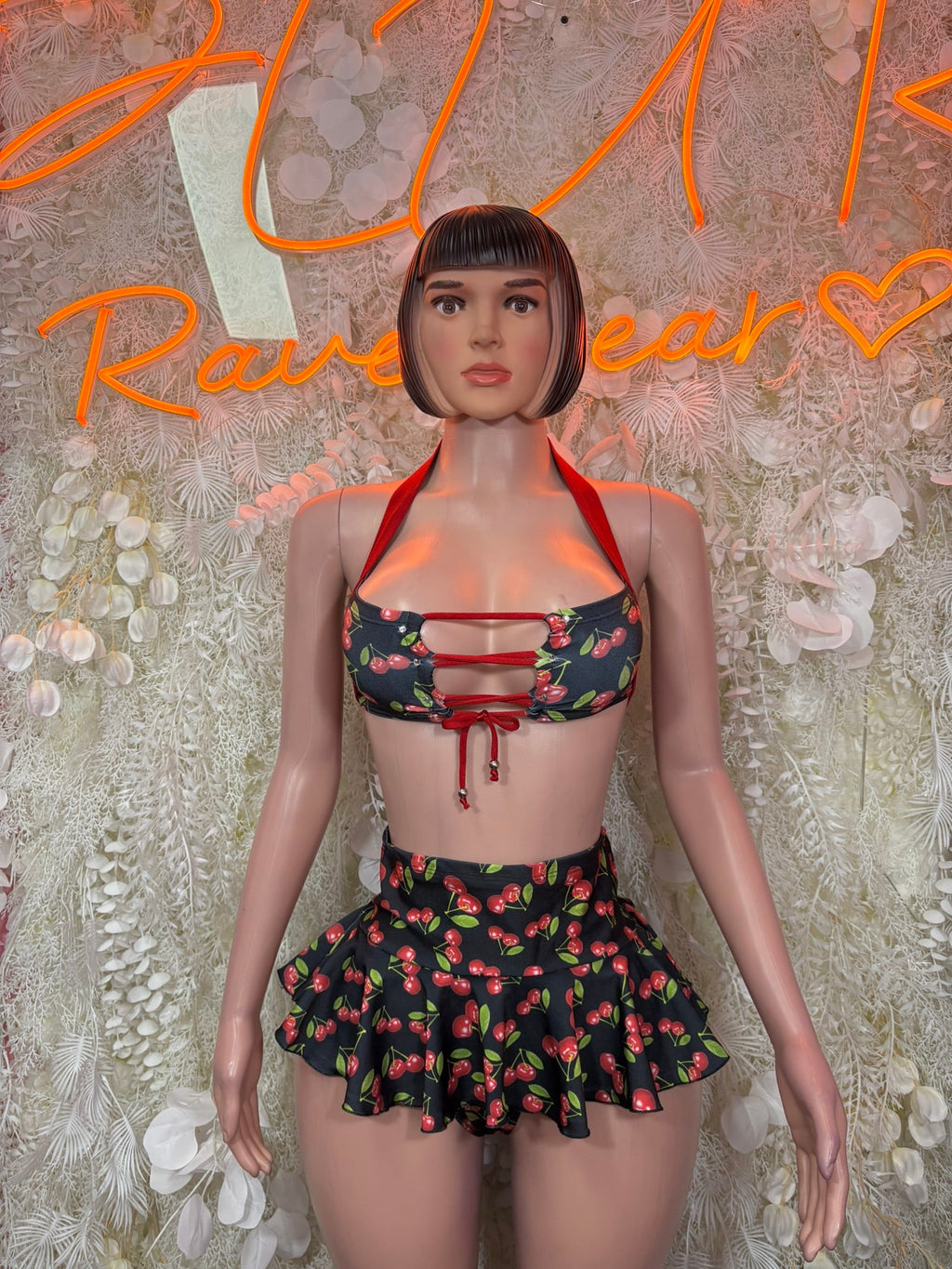 Cherry print halter bikini top and black ruffled skirt set with lace-up front ties