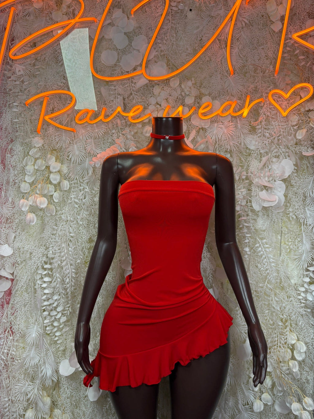 Red strapless ruched mini dress with gathered waist and ruffled hem