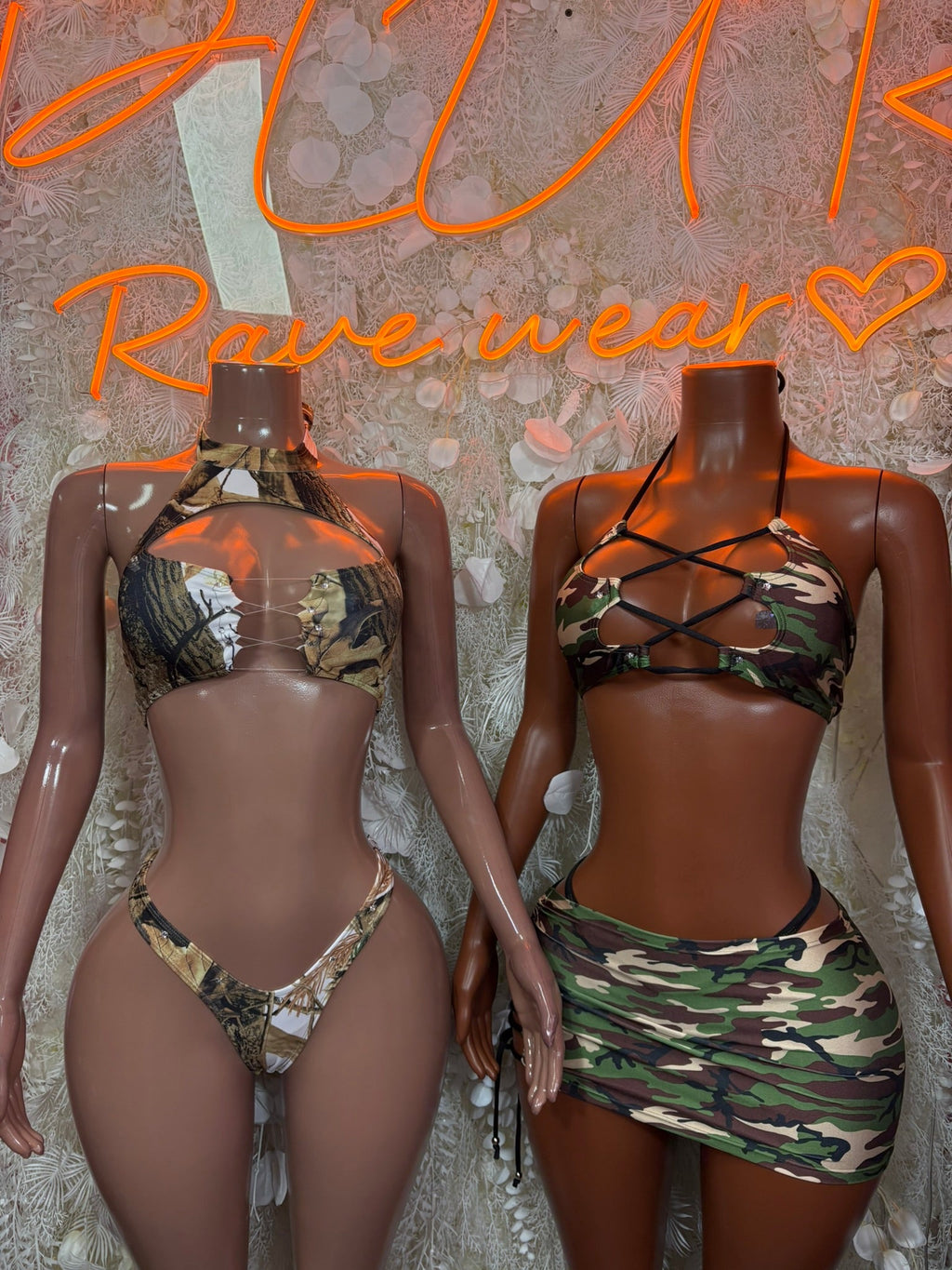 Two camo lace-up two-piece mini skirt sets with bandeau tops and short skirts