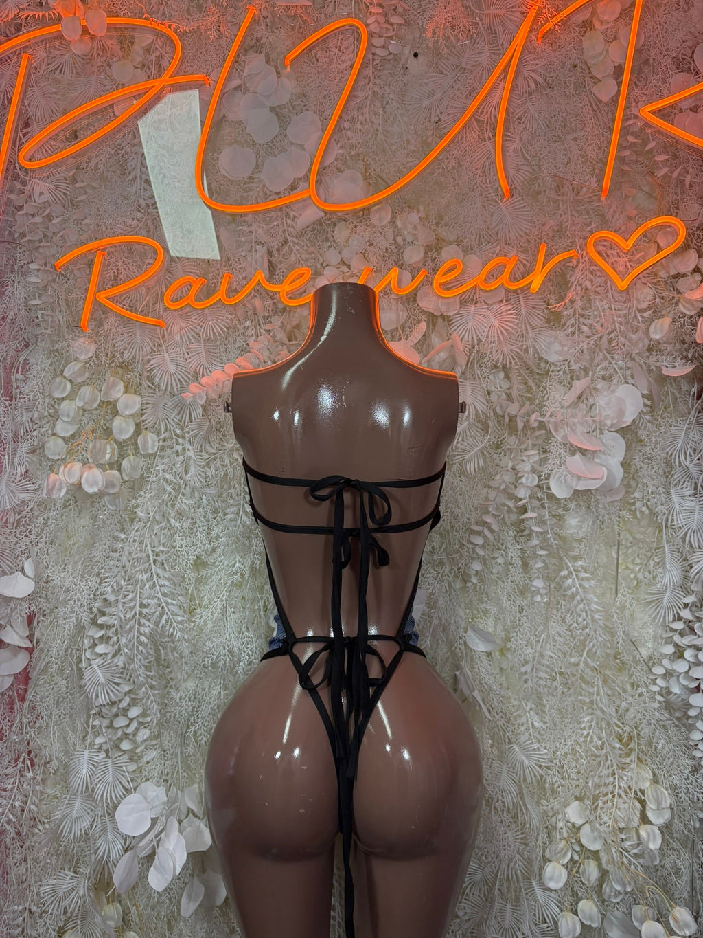 Black strappy cutout bodysuit with tie-back straps and open back