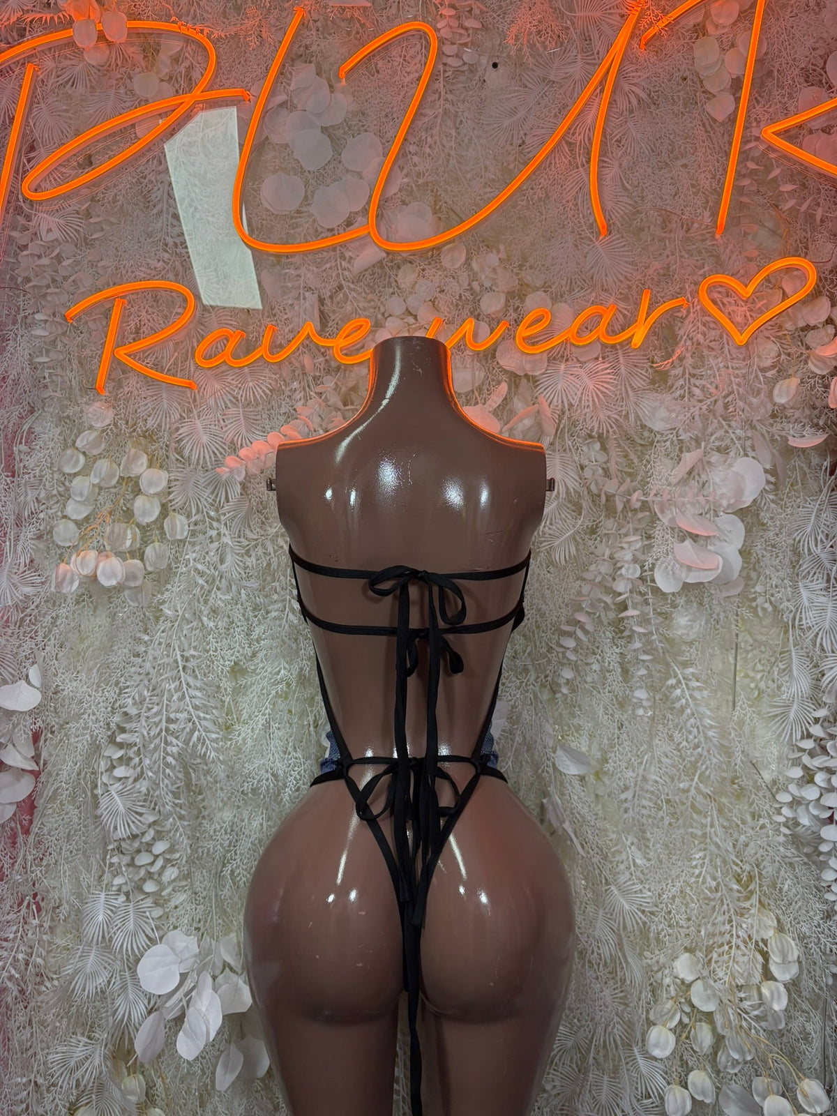 Black strappy cutout bodysuit with tie-back straps and open back