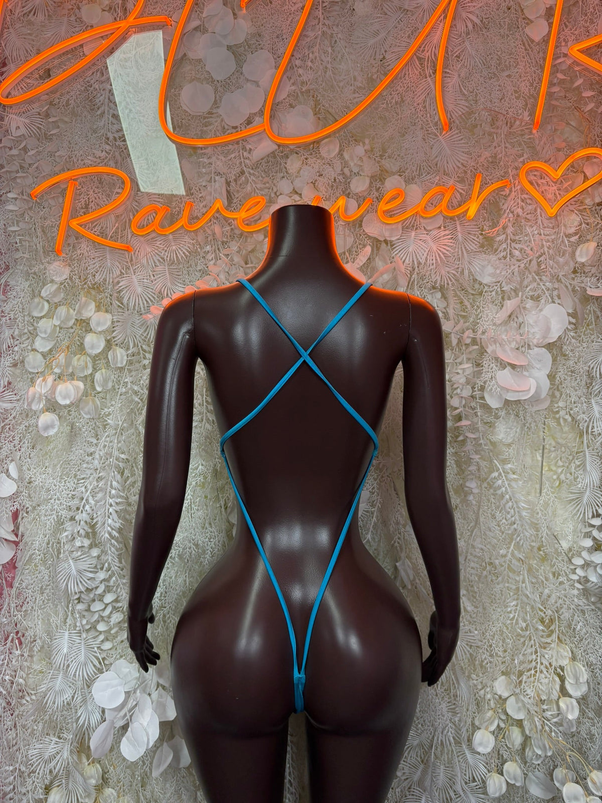 Blue ombre bodysuit with crisscross back straps and scoop neckline on a mannequin