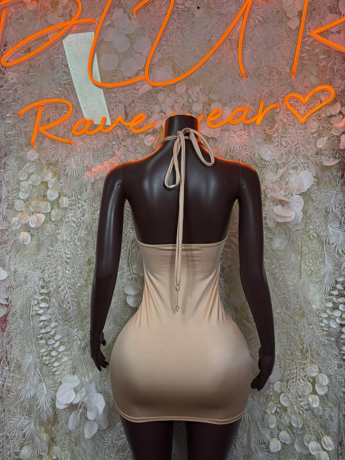 Nude mini dress with open back and tied halter strap