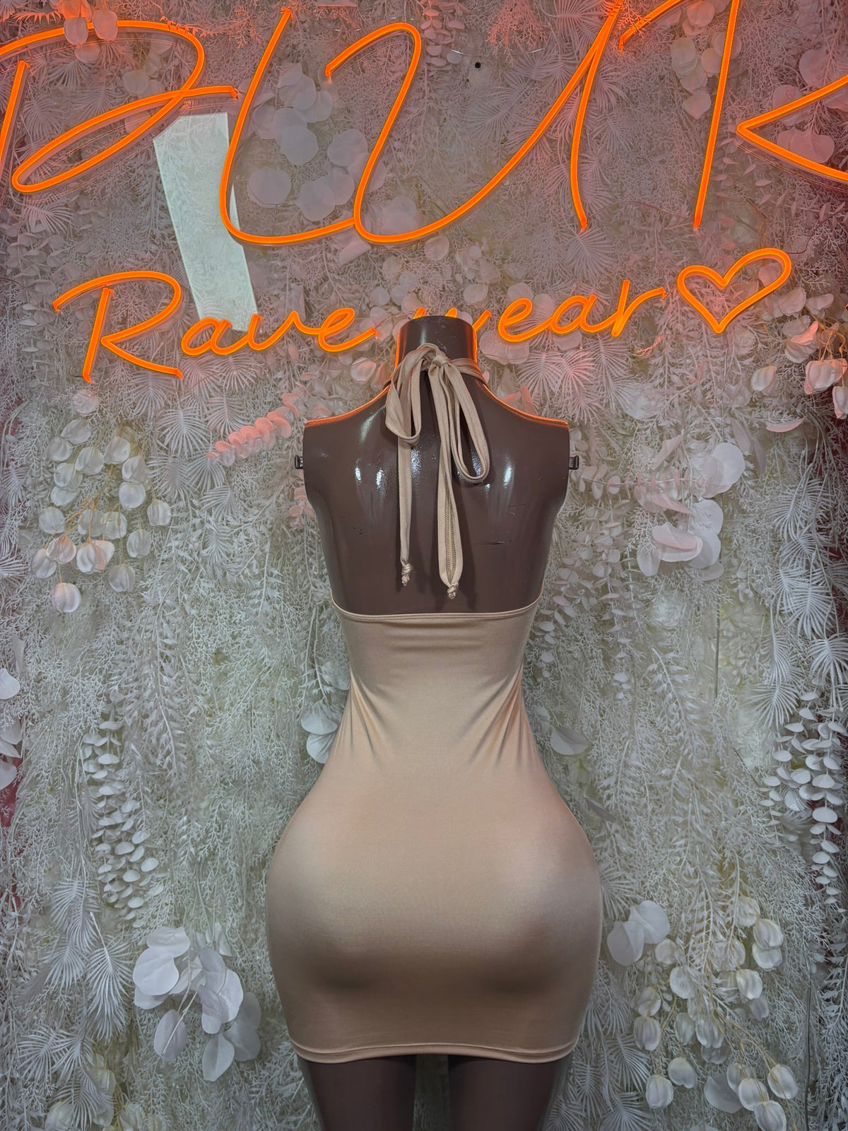 Nude halter mini dress with open back and neck-tie bow