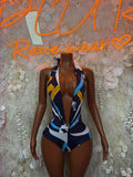 Navy geometric plunge one-piece swimsuit with yellow accents, low V neckline