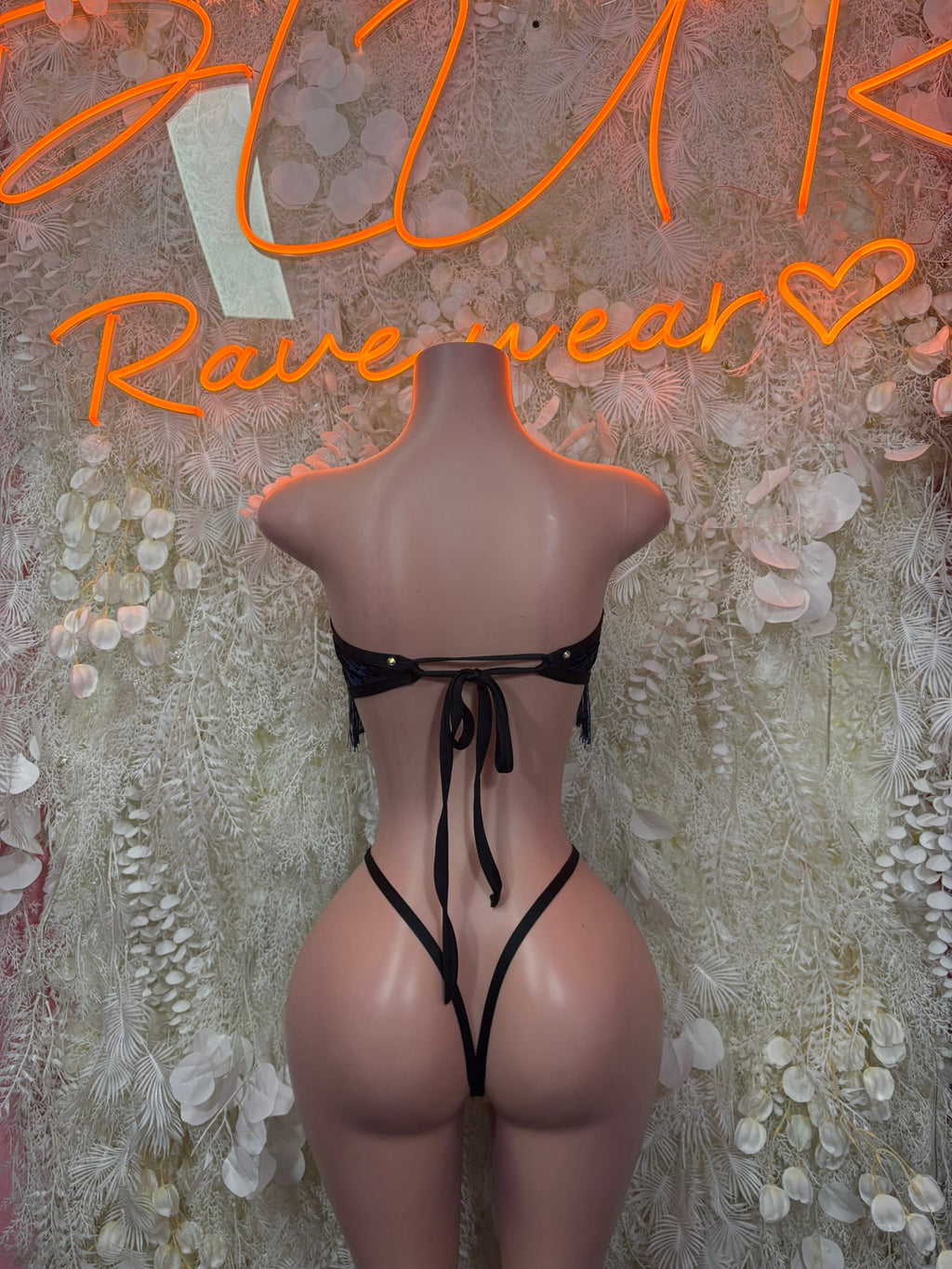 Black lace-up back cutout bodysuit with dangling fringe at hips
