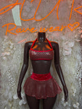 Red/black fishnet halter mini skirt set on mannequin, halter top and flared mini skirt.