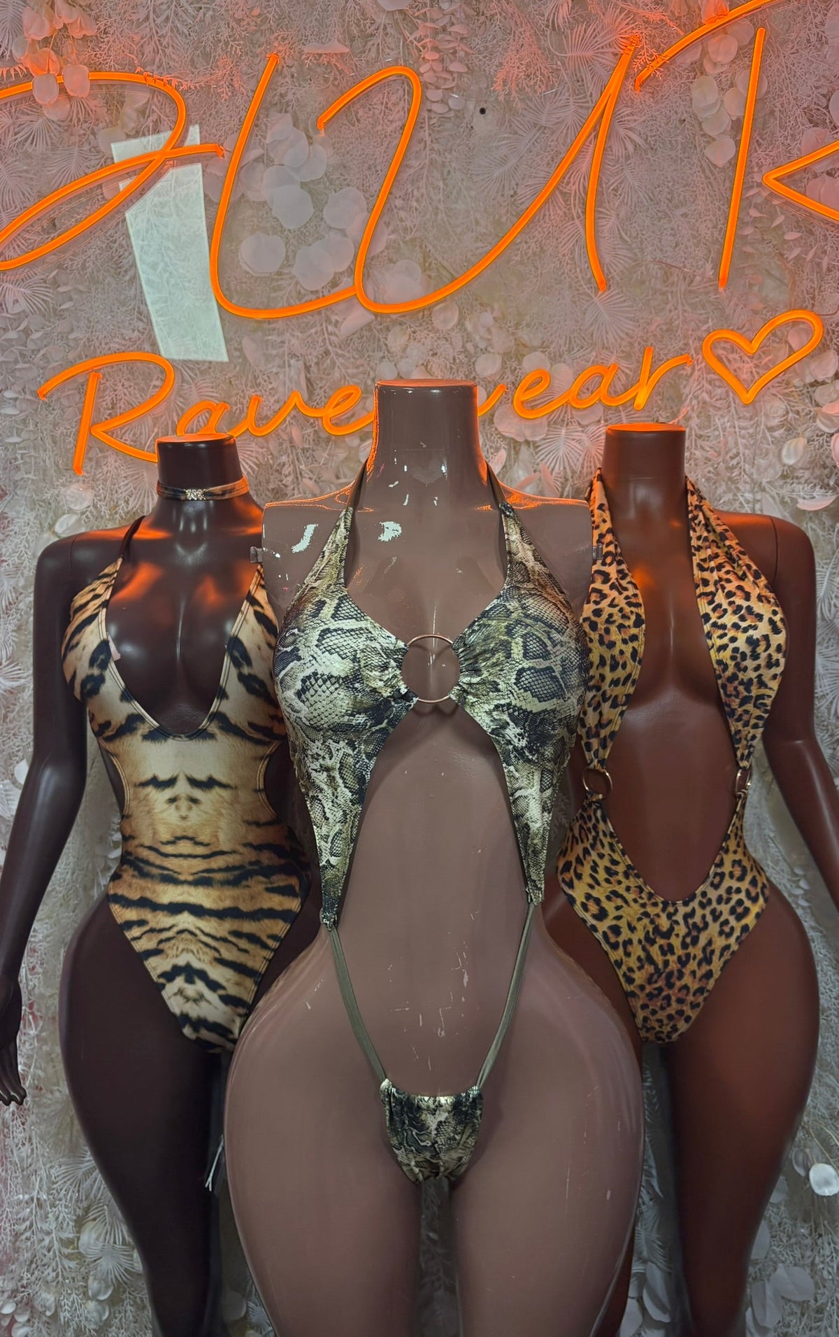 Three animal-print cutout bodysuits: zebra, snake, and leopard styles