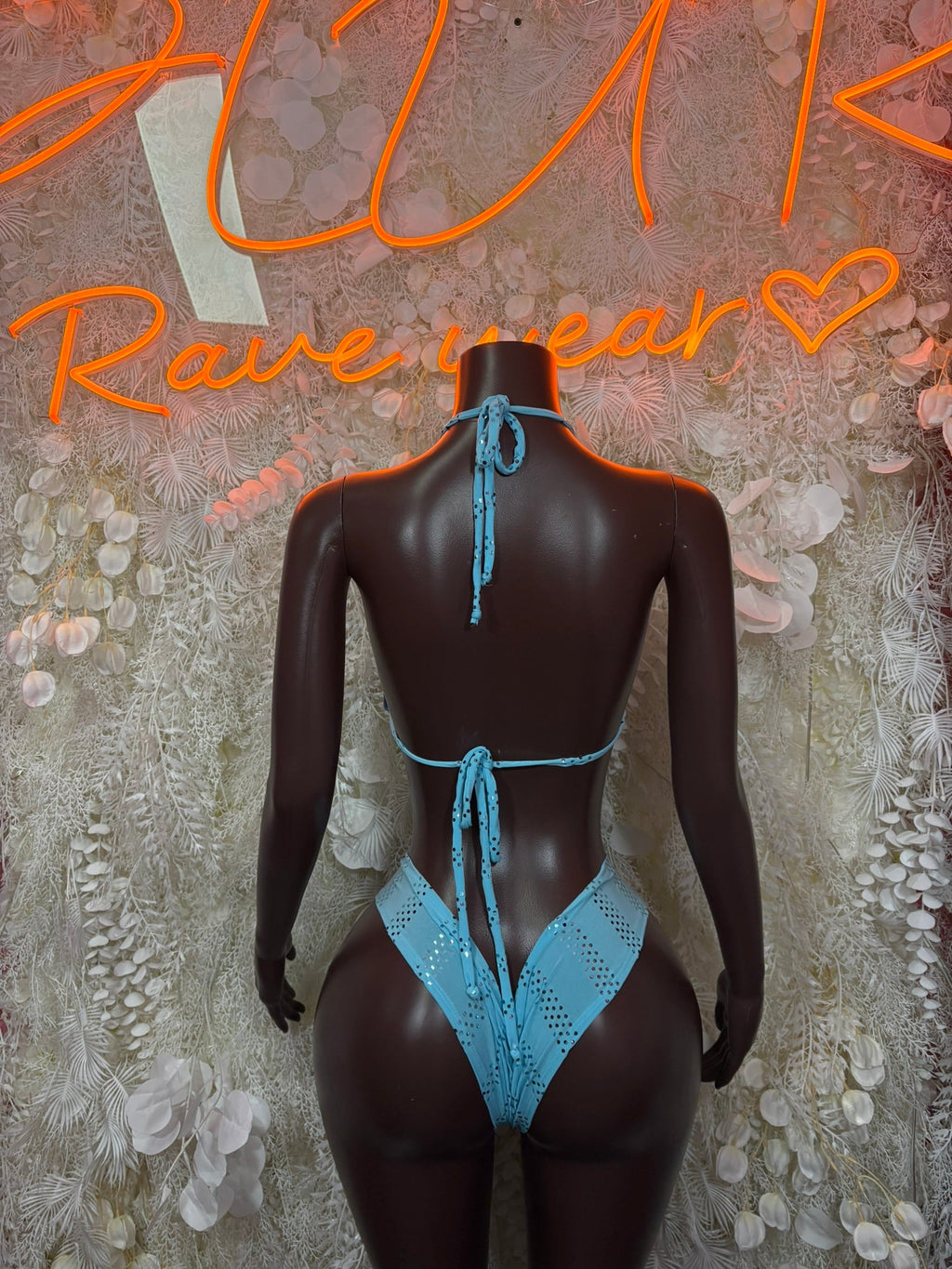Backless halter bodysuit with tie straps and high-cut bottom in light blue, on mannequin